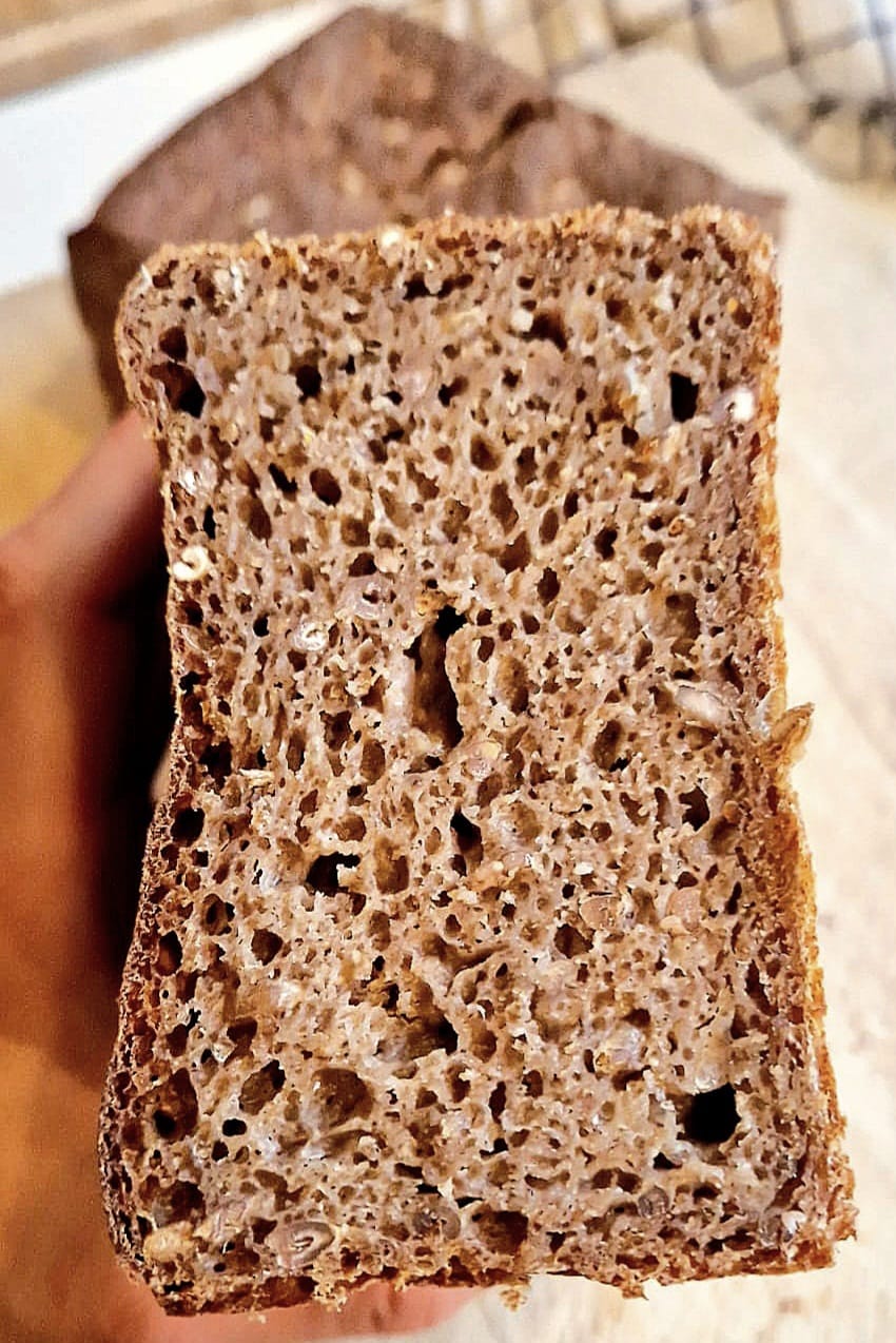 Sliced Danish rye bread (rugbrød) with a dense, dark crumb studded with whole rye berries