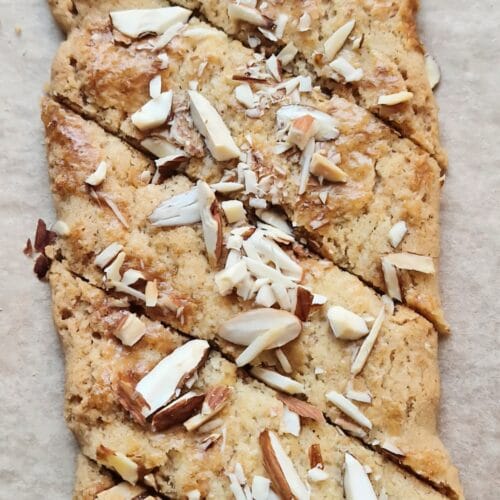 Brune pinner — thin diagonal Norwegian Christmas cookies topped with chopped almonds and sugar