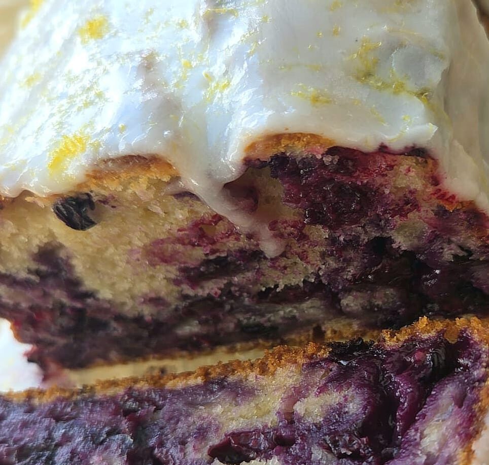 Sliced sourdough discard blueberry loaf with lemon glaze and lemon zest
