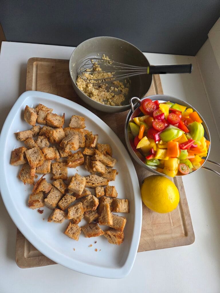 Sourdough croutons, chopped tomatoes and peppers ready for bread salad