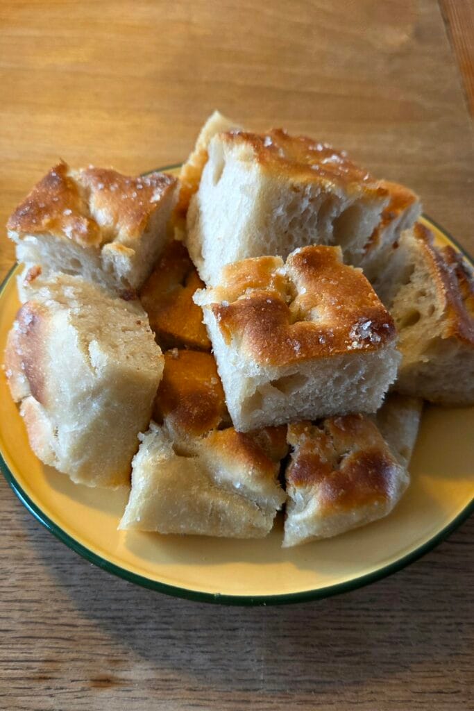 Pieces of sourdough focaccia in a bowl, ready to serve