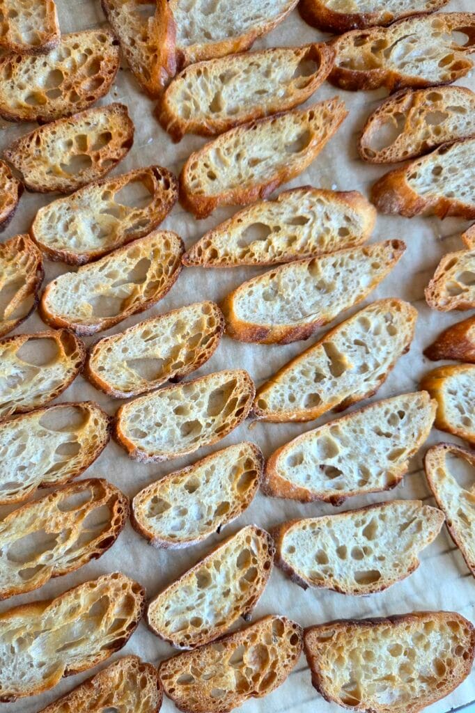 Crisp sourdough chips cooling on parchment after baking