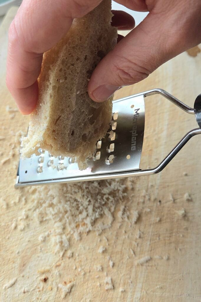 Grating frozen crustless sourdough by hand to make homemade panko
