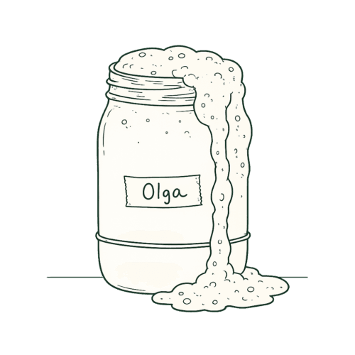 Overflowing sourdough starter jar labeled Olga