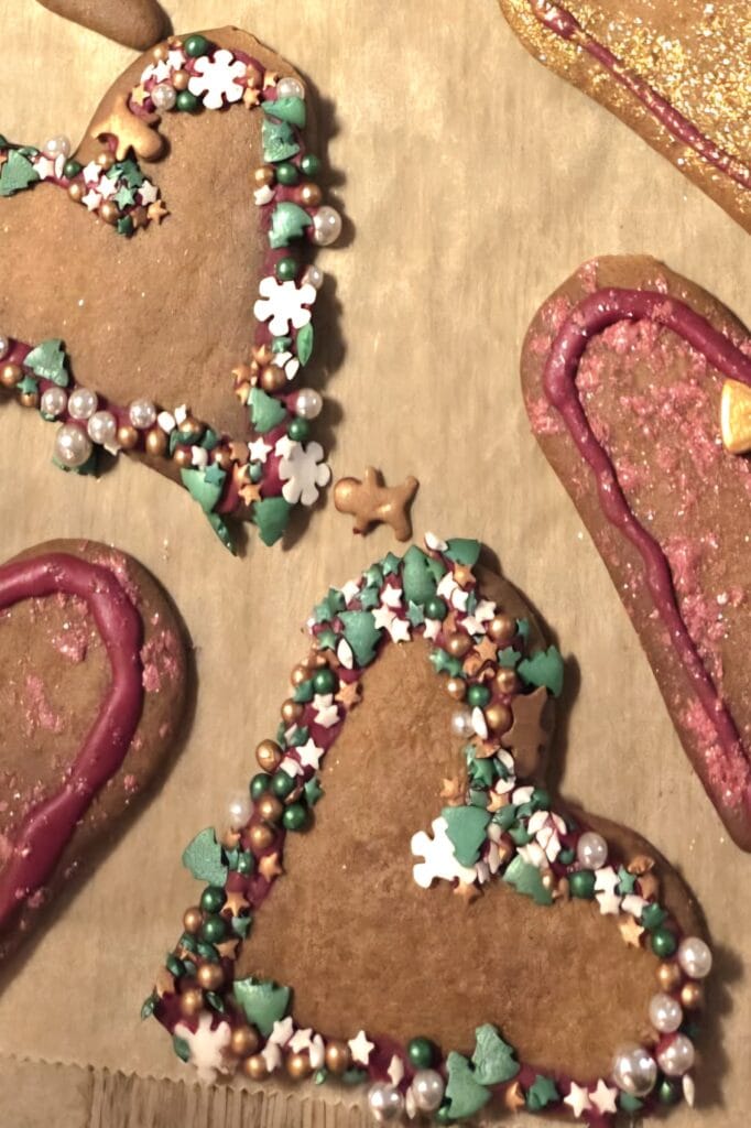 Pepperkaker decorated with piped royal icing, cured and ready to pack into a tin