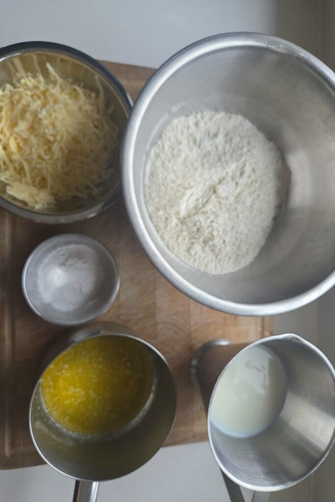 Ingredients for cheese scones: flour, baking powder, melted butter, milk and grated Jarlsberg