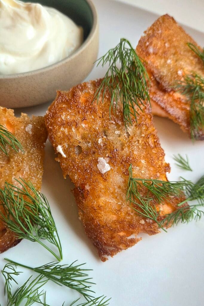 Sourdough-crusted salmon served crust side up with sour cream, dill and flaky salt