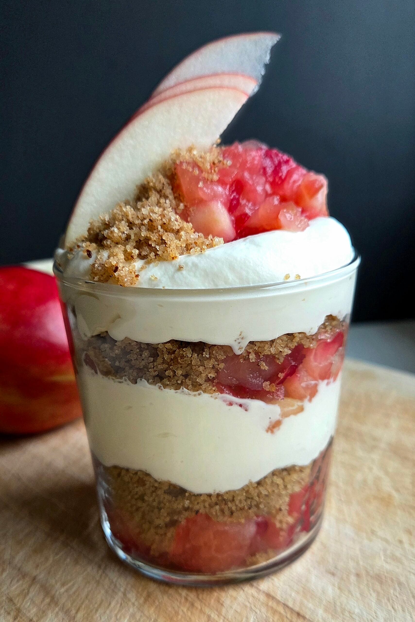 Norwegian apple trifle in a glass with layers of apple compote, buttered breadcrumbs and whipped cream