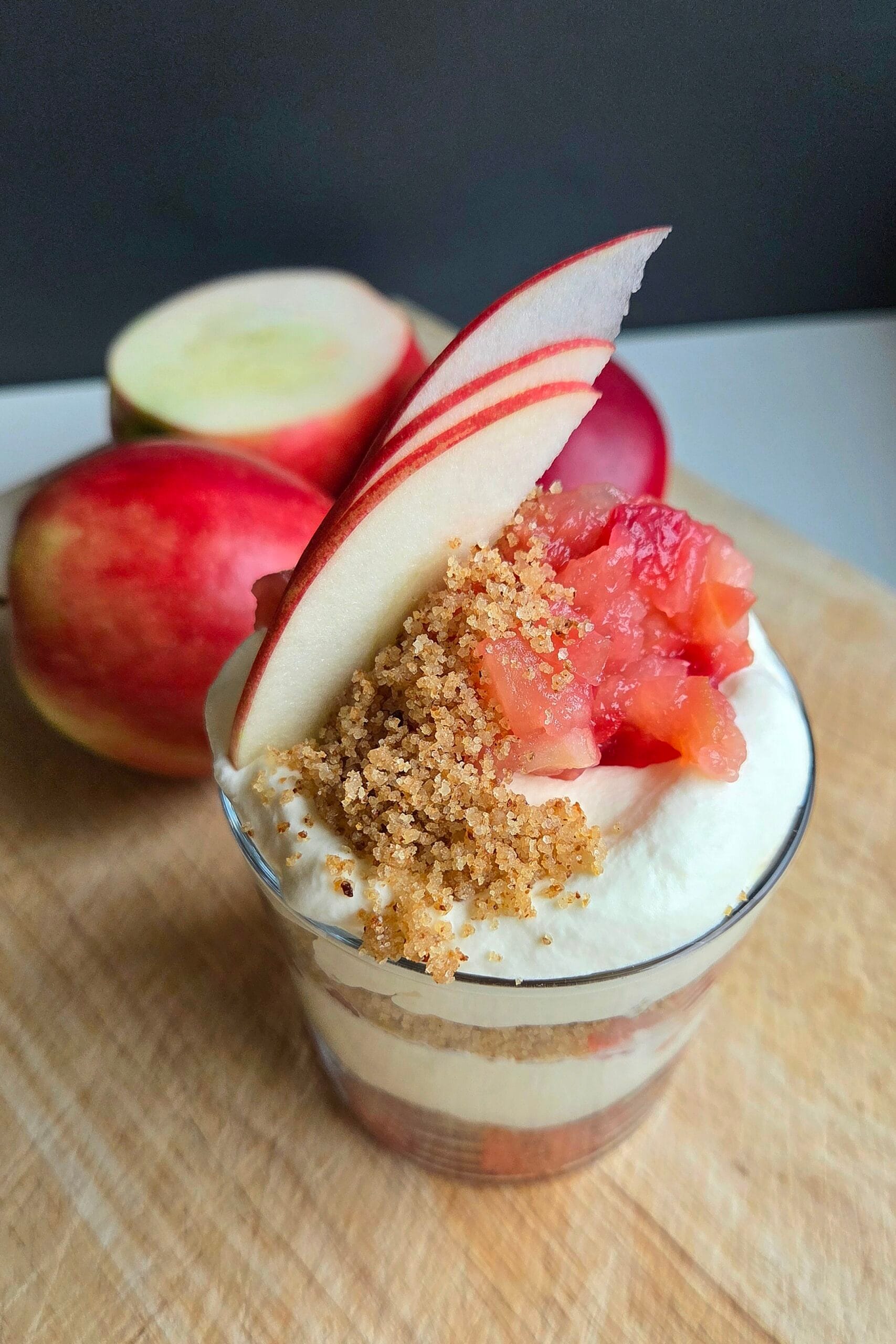 Norwegian apple trifle in a glass with layers of apple compote, buttered breadcrumbs and whipped cream