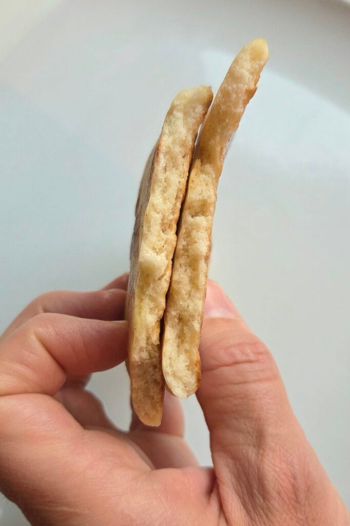 Sourdough discard naan torn open, showing the soft layered crumb inside