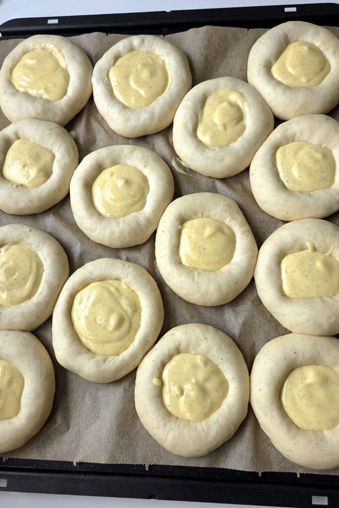 Thick, cold vanilla custard with visible vanilla seeds, whisked smooth and ready to fill skolebrød