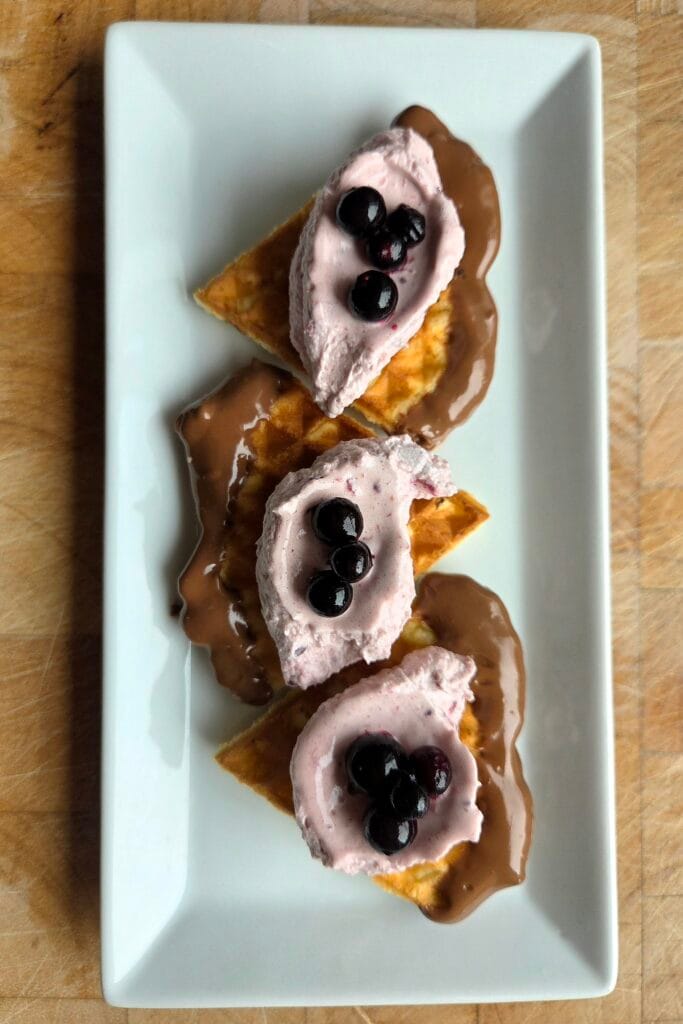 Crispy Norwegian waffles served with blackcurrant cream and whole berries